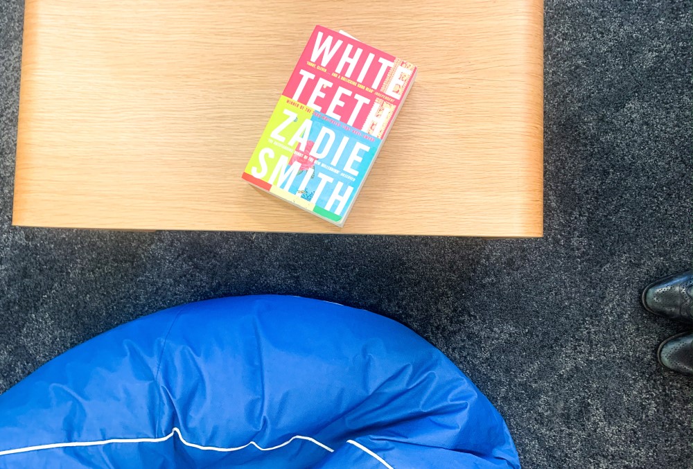 Capgemini Australia Graduate - Book on the table, a blue beanbag lounger, and shoes.